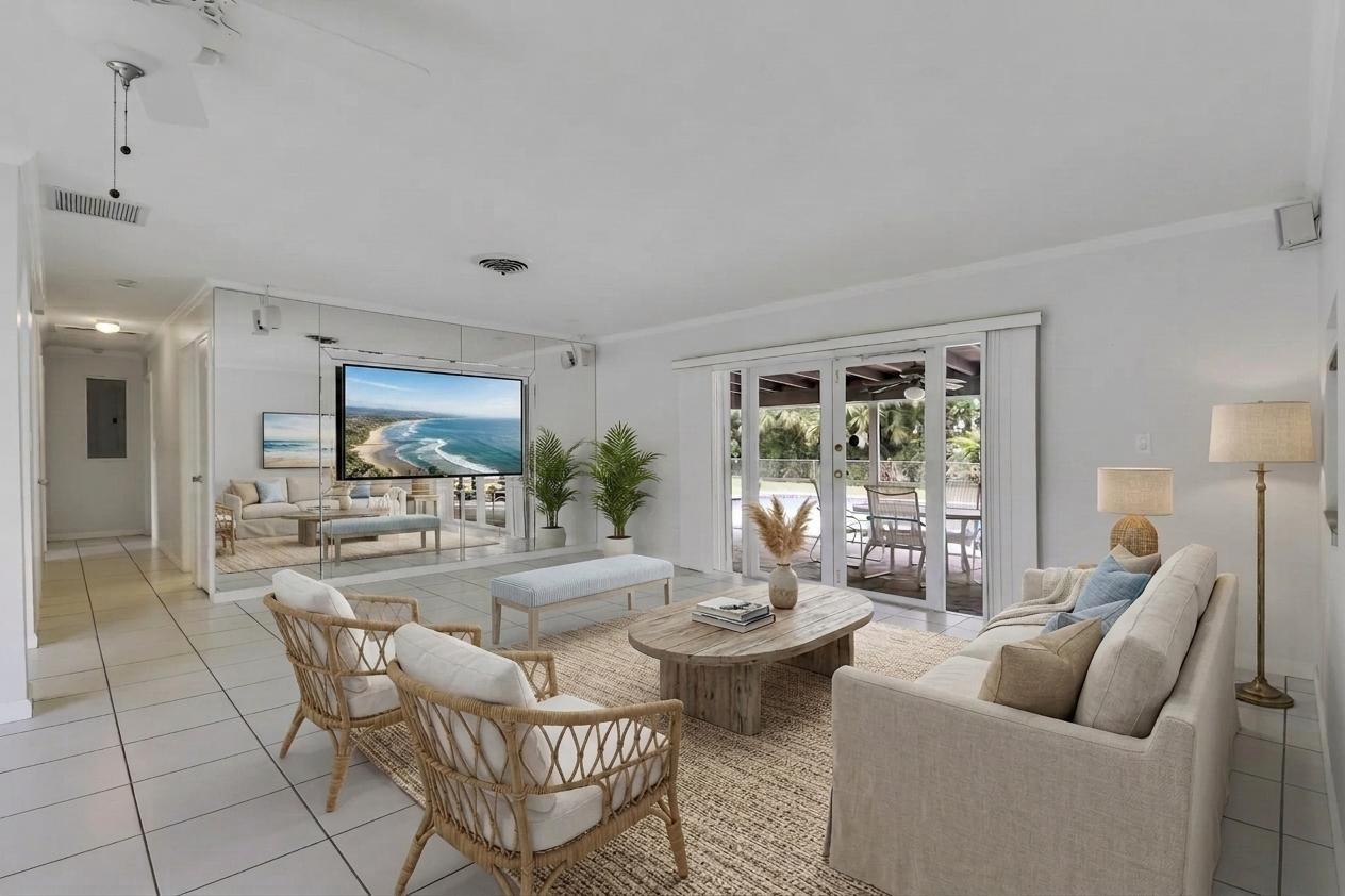 A living room with white tile floors, a mirrored wall, and sliding glass patio doors — 6824 Lakeside Road, West Palm Beach FL 33411, WEST PALM BEACH, FL