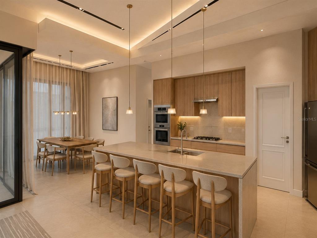A modern kitchen features a large island with bar stools, wood cabinetry, and dining area — 15340 RED HEAD AVENUE, PORT CHARLOTTE, FL