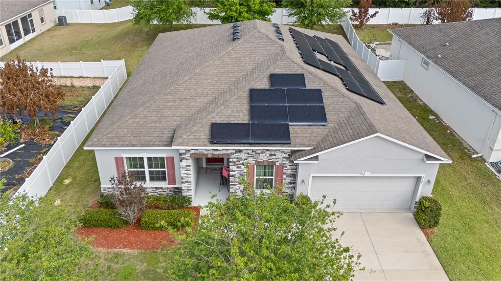 An aerial view of a single-story house with solar panels installed on the roof — 3609 APOPKA RIDGE CIR, APOPKA, FL