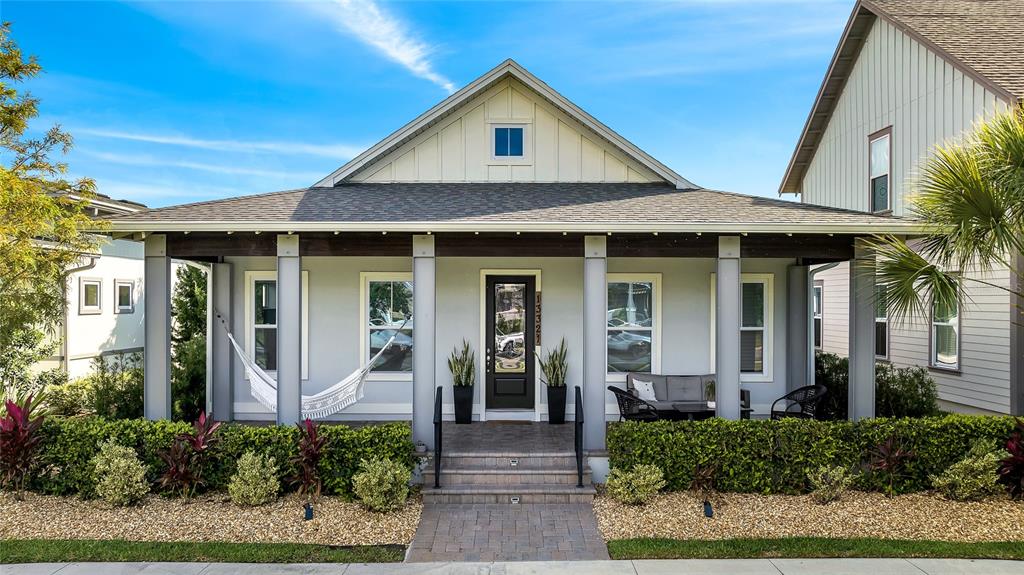 A single-story house with a covered front porch, a hammock, and a landscaped front yard — 13321 BEEBE ALLEY, ORLANDO, FL