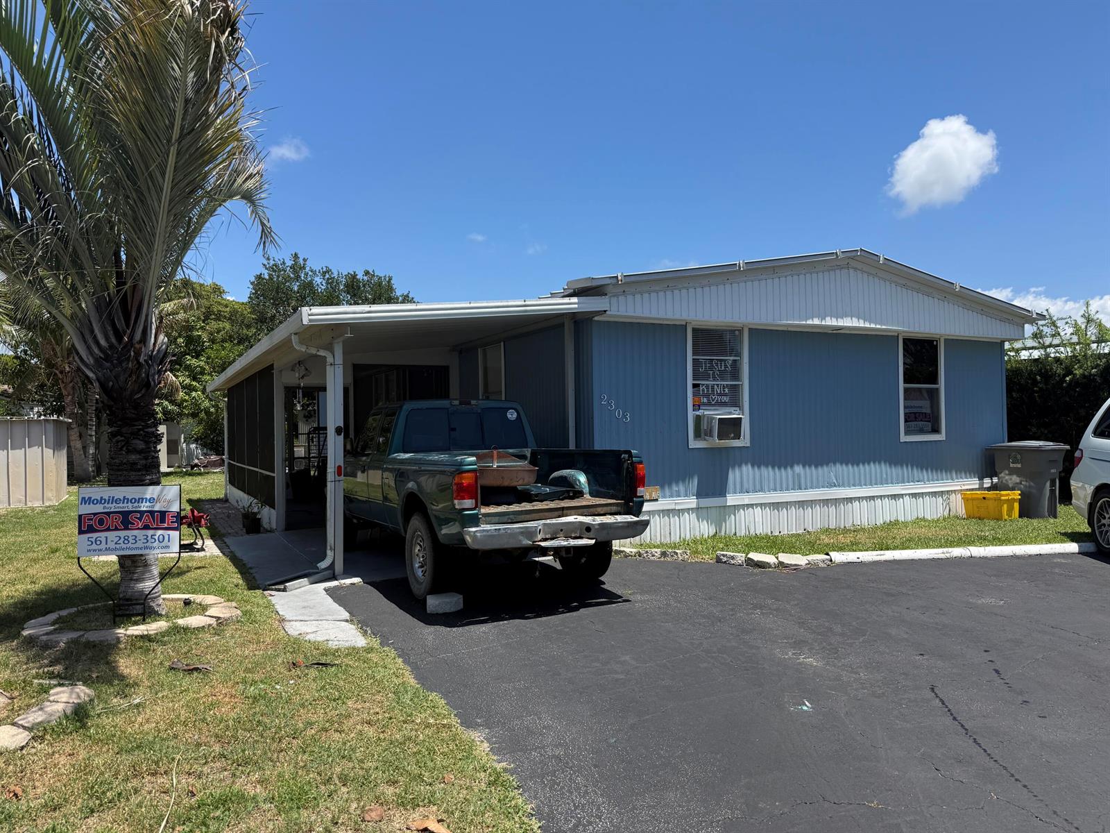 A blue mobile home with a carport, a pickup truck, and a for-sale sign — 2303 NW 14th Avenue # 534, Boynton Beach FL 33436, BOYNTON BEACH, FL