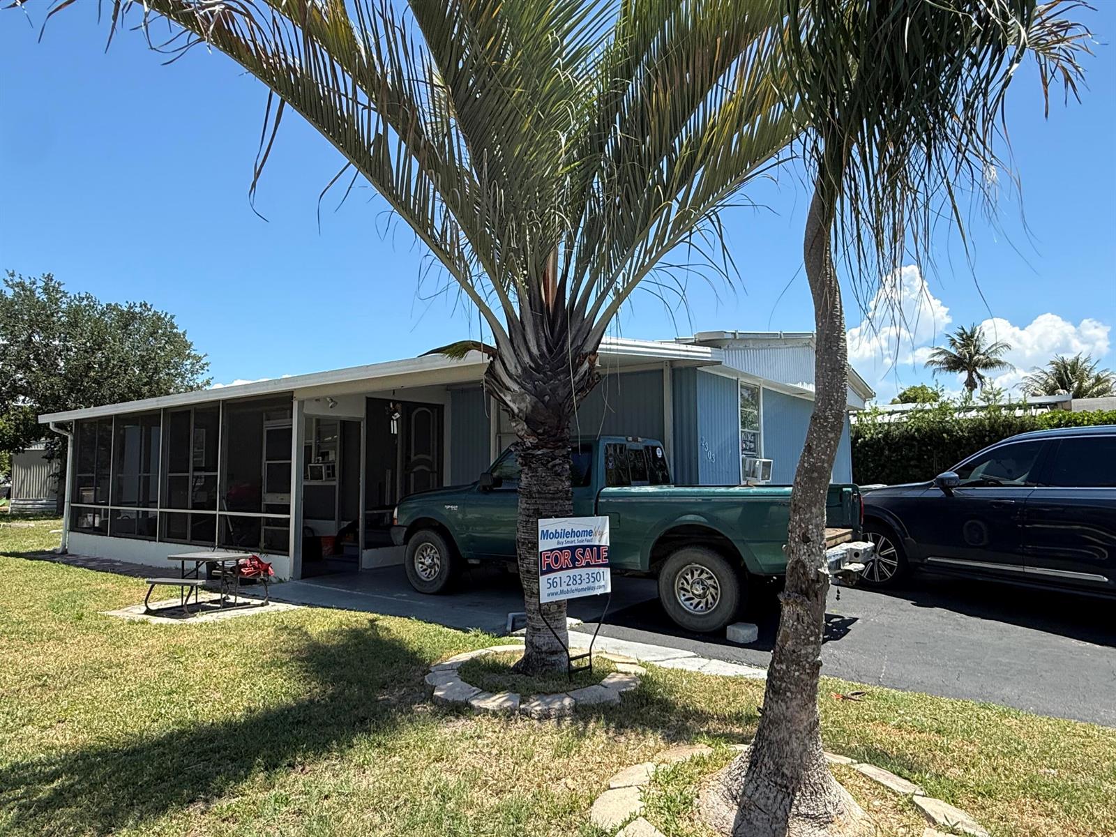 A mobile home with a screened-in porch and a green pickup truck parked in front — 2303 NW 14th Avenue # 534, Boynton Beach FL 33436, BOYNTON BEACH, FL