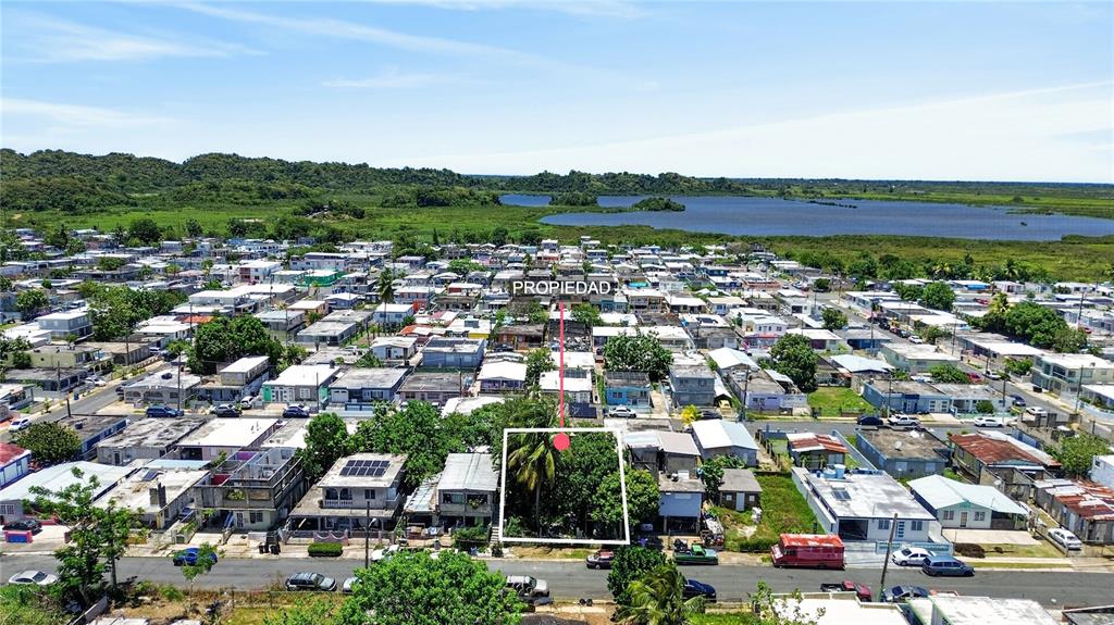 An aerial view shows a vacant, tree-covered lot situated within a dense residential neighborhood — 11 ST. EXT. JARDINES DE PALMAREJO, V-20, CANOVANAS, PR