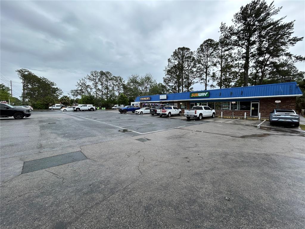 A single-story commercial building with a Subway restaurant and a parking lot in front — 203-221 NE 39TH AVENUE, GAINESVILLE, FL