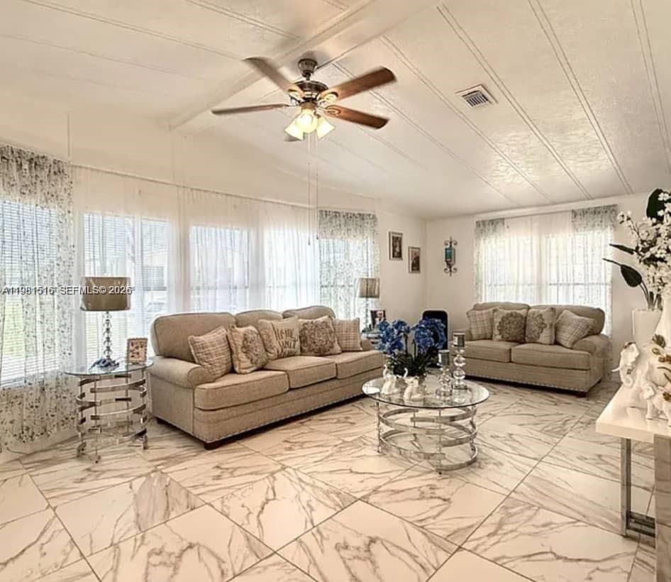 A living room features light-colored sofas, a glass coffee table, and marble-patterned tile flooring — 215 LAURELCREST CIR VALRICO, Brandon FL 33594, BRANDON, FL