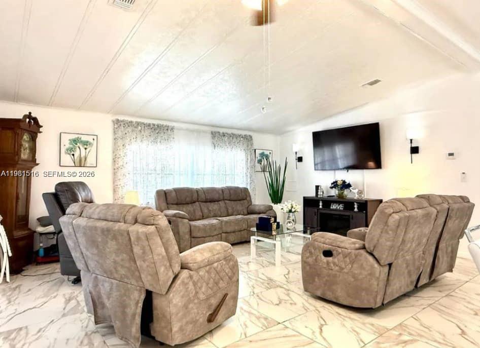 A living room features light-colored marble-patterned tile floors, a sofa, and two reclining chairs — 215 LAURELCREST CIR VALRICO, Brandon FL 33594, BRANDON, FL