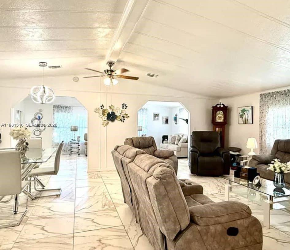 A living room and dining area with white marble-patterned tile floors and vaulted ceilings — 215 LAURELCREST CIR VALRICO, Brandon FL 33594, BRANDON, FL