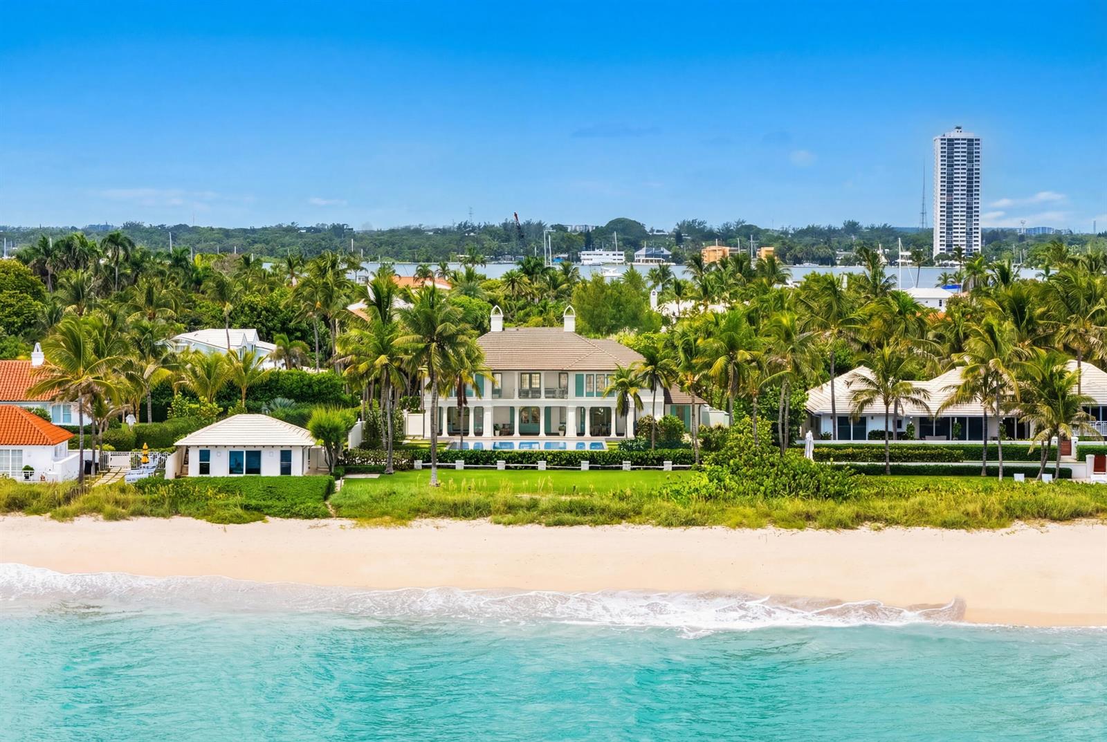 An aerial view of a beachfront house with a pool, surrounded by palm trees and vegetation — 1285 N Ocean Boulevard, Palm Beach FL 33480, PALM BEACH, FL