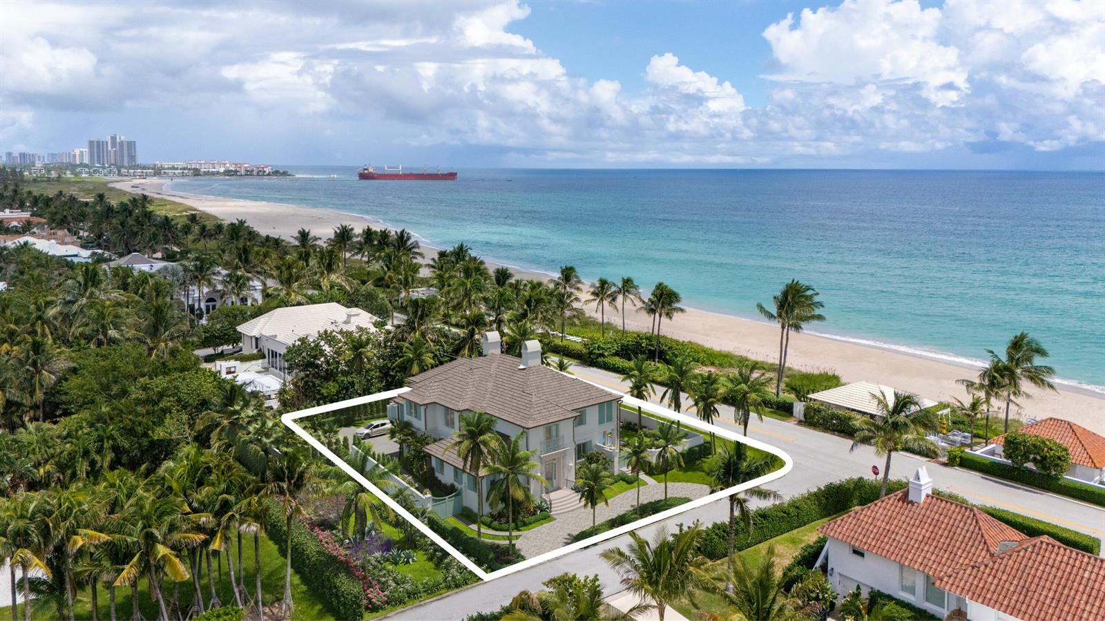 An aerial view of a two-story house with a tiled roof near a sandy beach — 1285 N Ocean Boulevard, Palm Beach FL 33480, PALM BEACH, FL