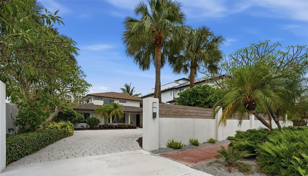 An aerial view of a waterfront home with a pool, surrounded by lush tropical landscaping — 541 S WASHINGTON DRIVE, SARASOTA, FL