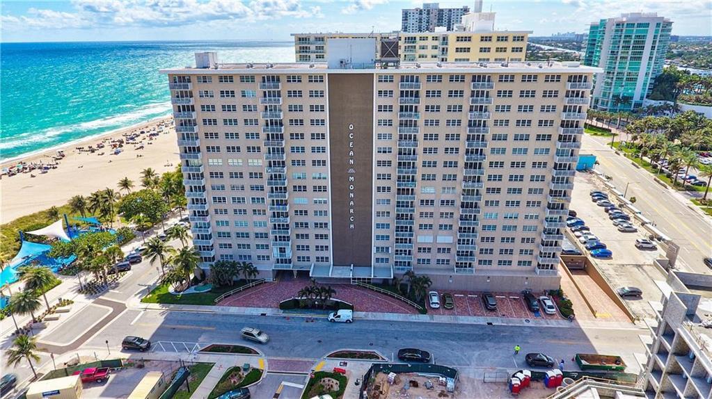 An aerial view shows the Ocean Monarch residential building situated next to a sandy beach — 133 N Pompano Beach Boulevard # 108, Pompano Beach FL 33062, POMPANO BEACH, FL