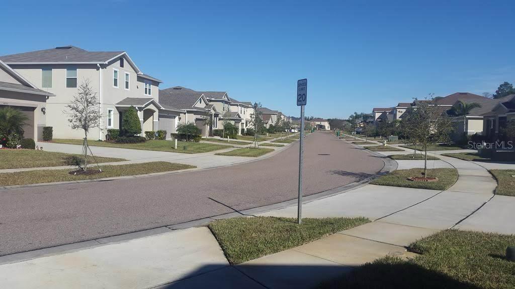 An entryway with tile flooring, a white front door, and a television on a stand — 4752 BLUE DIAMOND STREET, KISSIMMEE, FL