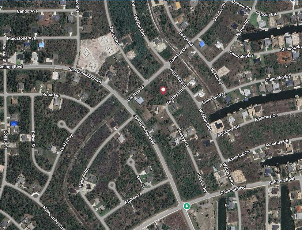 This is an aerial map showing residential streets and vacant lots in a wooded area — 8177 SCOBEY ROAD, PORT CHARLOTTE, FL