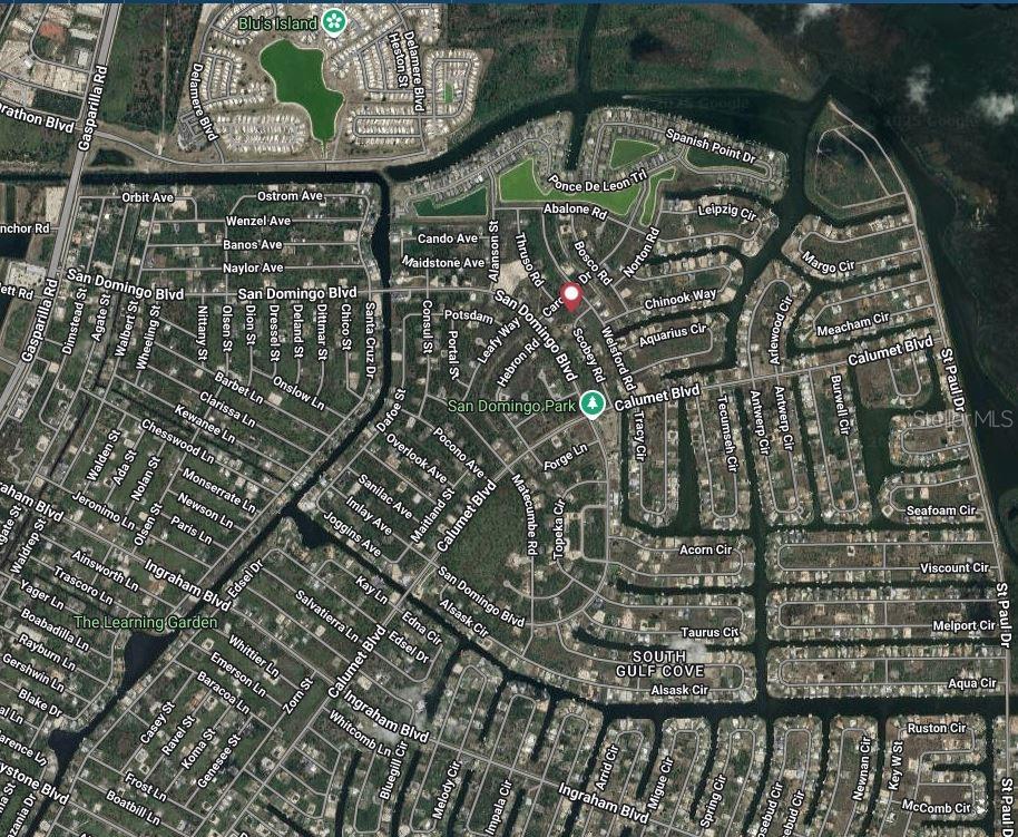 This is an aerial map view of a residential neighborhood with streets and green spaces — 8177 SCOBEY ROAD, PORT CHARLOTTE, FL