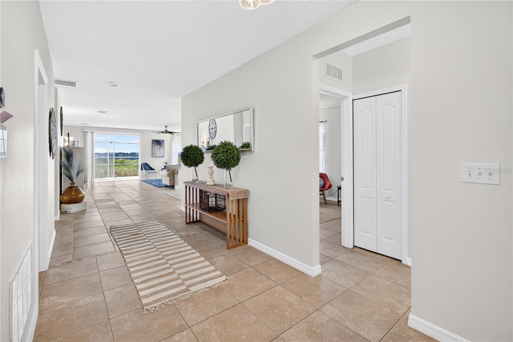 A tiled entryway leads to a living area with a sliding glass door and view — 713 BLACK EAGLE DRIVE, GROVELAND, FL