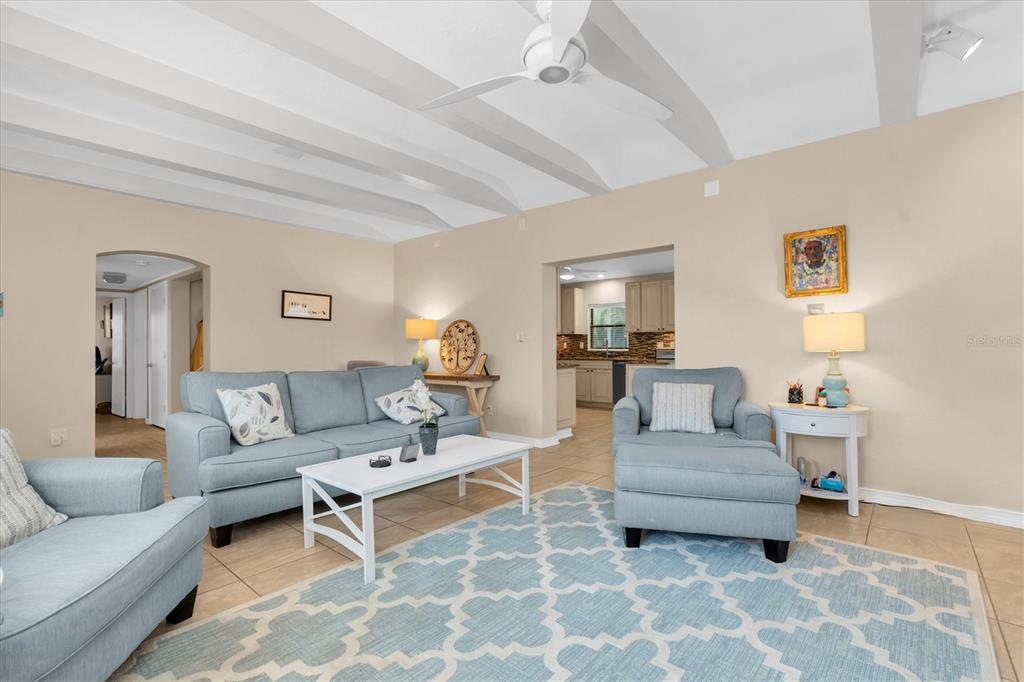 A living room features light blue furniture, a white coffee table, and a patterned rug — 6237 13TH AVENUE S, GULFPORT, FL