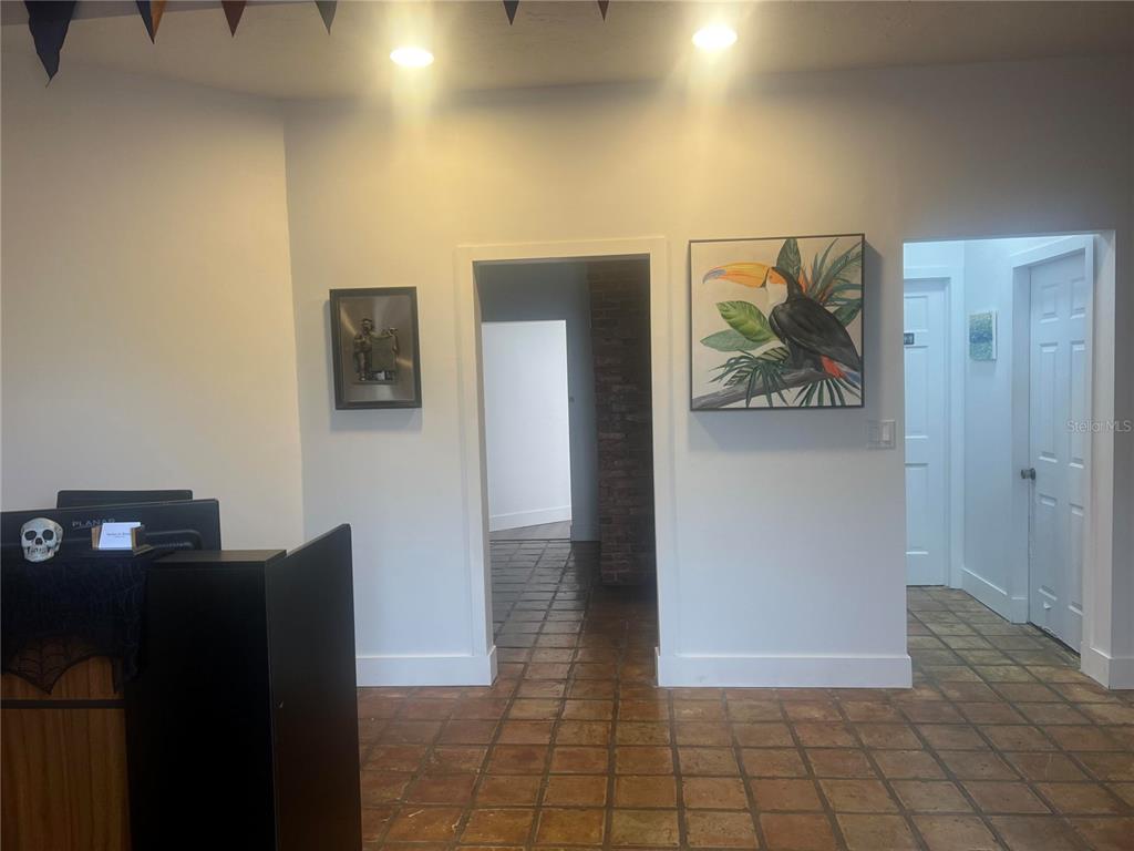An interior view of a room with tiled flooring, a reception desk, and two doorways — 856 2ND AVENUE N, ST PETERSBURG, FL