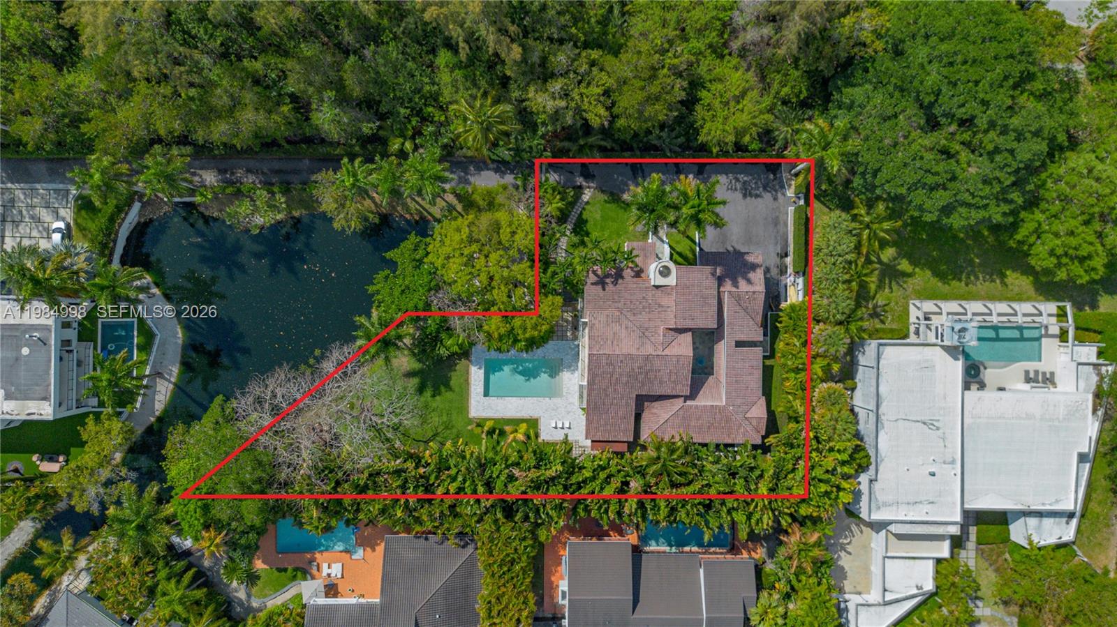 An aerial view shows a house with a swimming pool on a landscaped lot — 5981 SW 136th St, Pinecrest FL 33156, PINECREST, FL