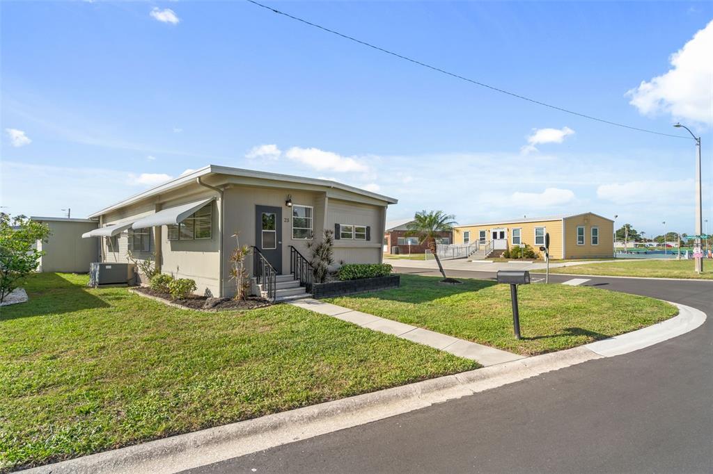 A beige single-story house with a small front porch and a concrete walkway — 2900 8TH AVENUE W UNIT 23, PALMETTO, FL