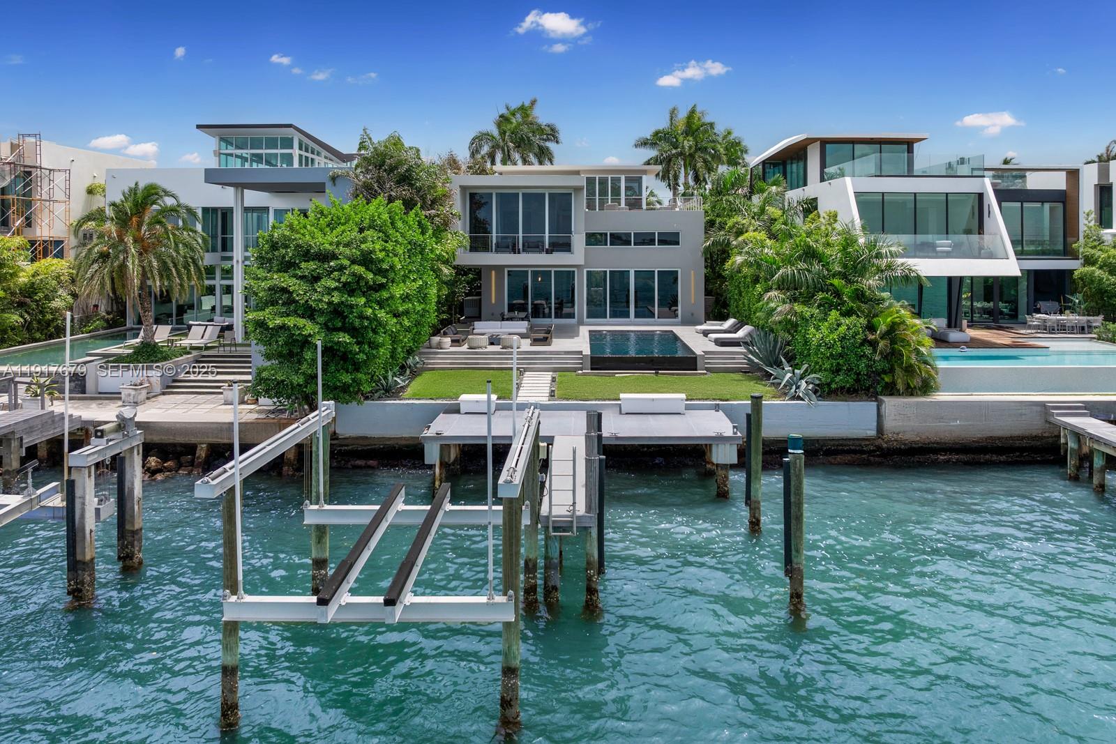 An aerial view of a modern waterfront home with a private dock and swimming pool — 1379 N Venetian Way, Miami FL 33139, MIAMI, FL