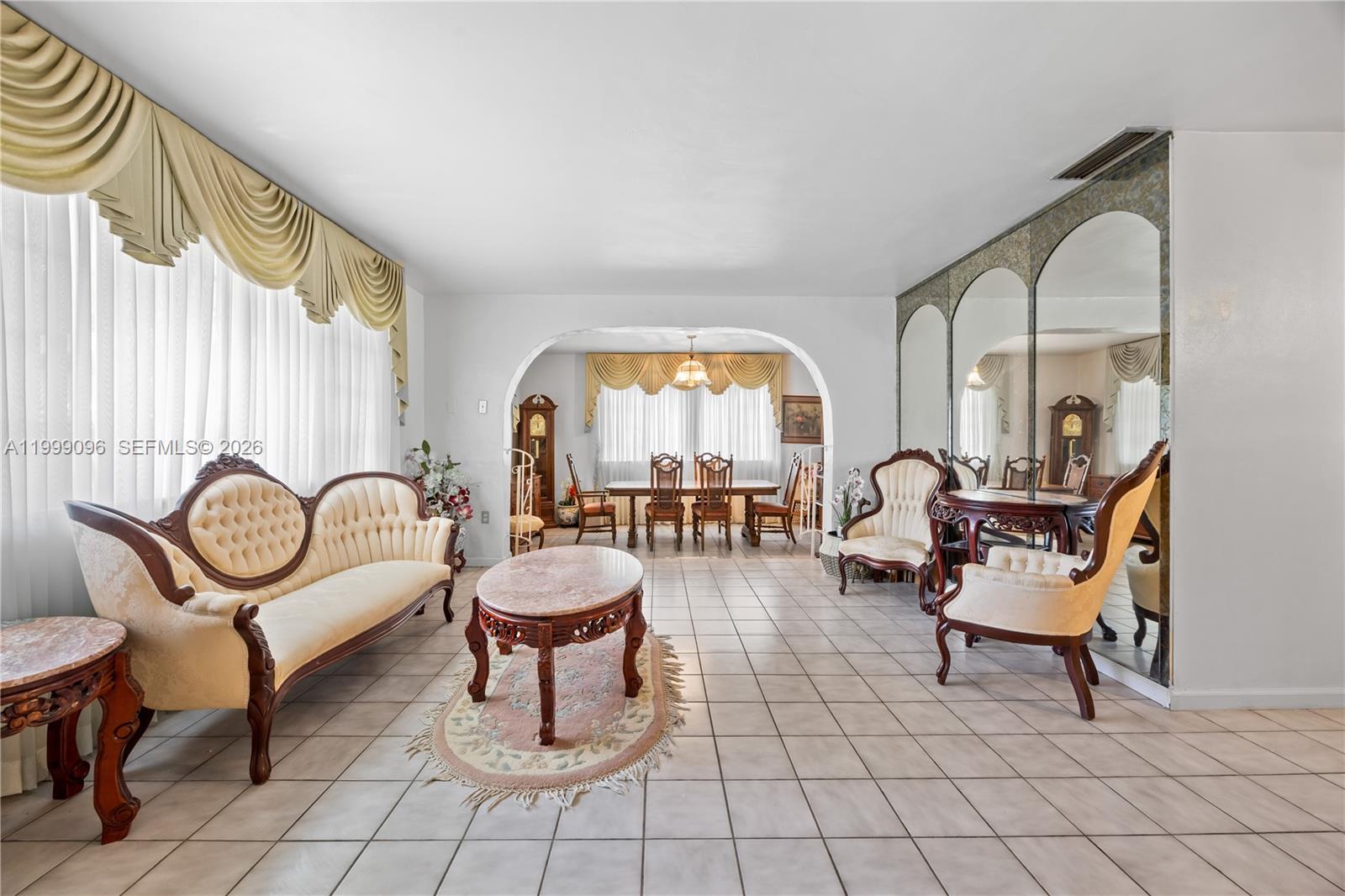 A living and dining area features tiled floors, arched entryways, and traditional ornate furniture — 11298 NW 21st Ct, Miami FL 33167, MIAMI, FL