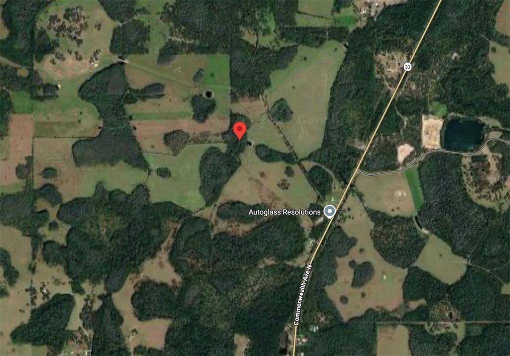This is a satellite map view showing a red location pin on a rural property — POLK CITY, POLK CITY, FL
