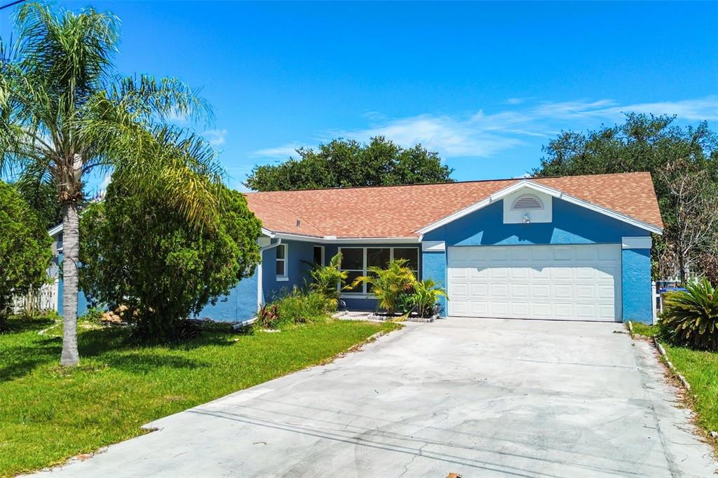 An aerial view shows a suburban neighborhood with single-family homes, driveways, and green lawns — 760 DEL PRADO DRIVE, KISSIMMEE, FL