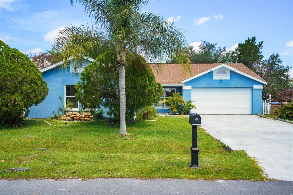 A spacious living area with light wood-look flooring, a ceiling fan, and an open kitchen — 760 DEL PRADO DRIVE, KISSIMMEE, FL