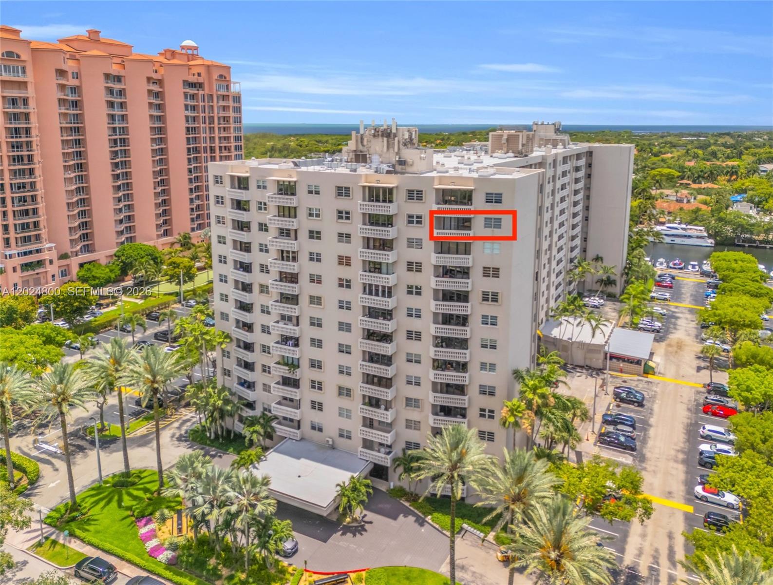 An aerial view shows a multi-story apartment building with a red box highlighting a balcony — 90 Edgewater Dr # 1201, Coral Gables FL 33133, CORAL GABLES, FL
