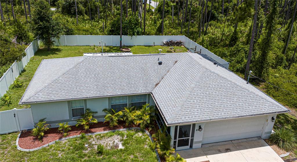 An aerial view of a single-story house with a gray shingled roof and fenced yard — 8457 BRISTOL AVENUE, NORTH PORT, FL