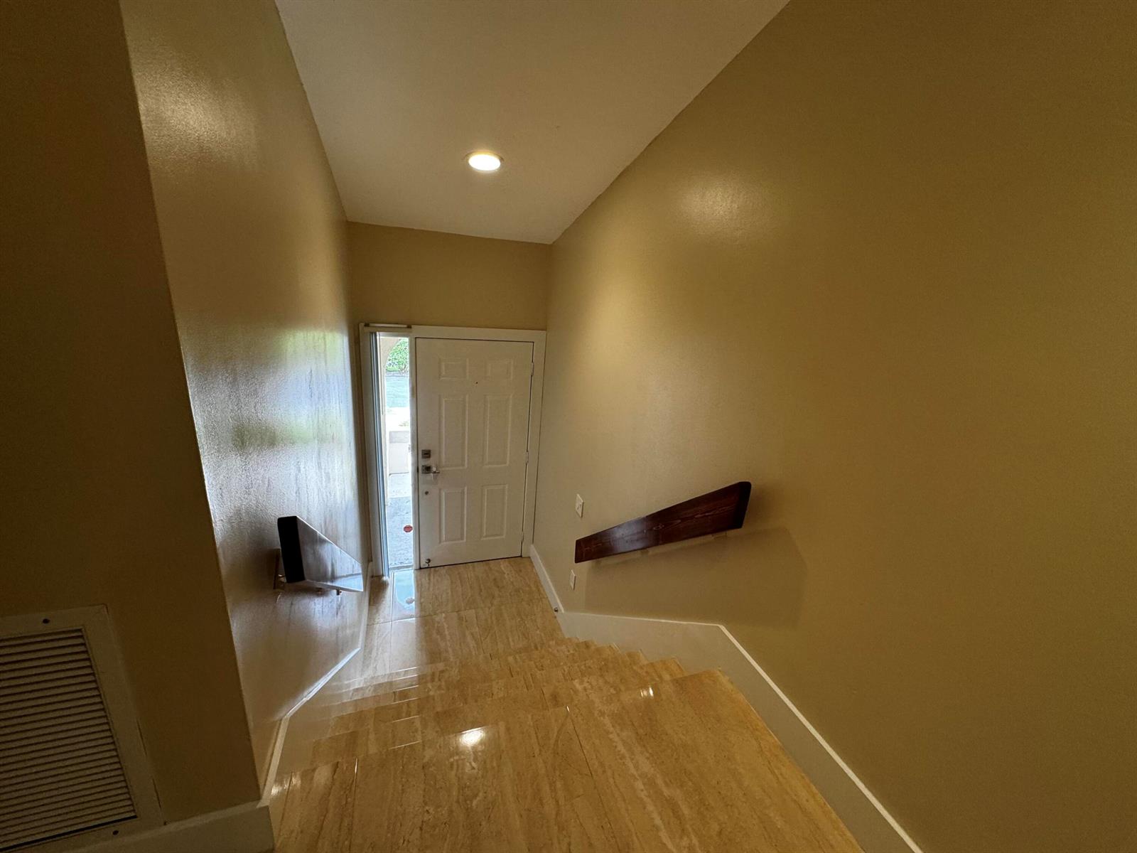 A staircase with tan stone steps leads down to a white front door — 5520 Coach House Circle # G, Boca Raton FL 33486, BOCA RATON, FL