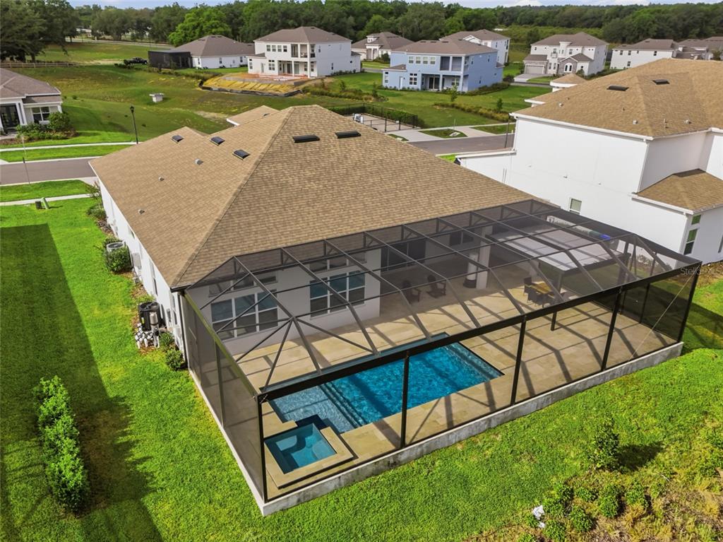 An aerial view of a house with a screened-in pool, spa, and patio — 16071 BARKLY RIDGE COURT, WINTER GARDEN, FL