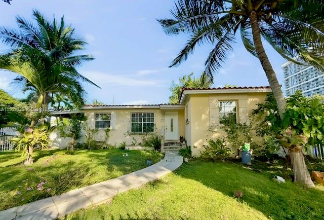 A single-story house with a light yellow exterior, a front walkway, and surrounding palm trees — 2701 SW 29th Ave, Miami FL 33133, MIAMI, FL