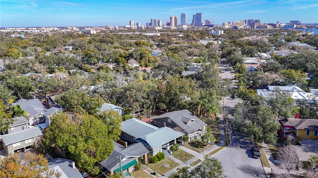 An aerial view of a residential neighborhood with houses and a city skyline in distance — 2105 W SOUTHVIEW AVENUE, TAMPA, FL