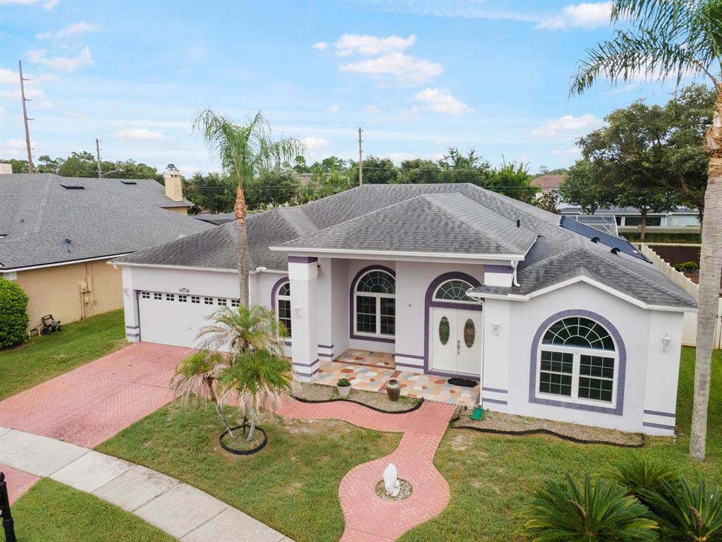 An aerial view of a single-story house with a purple-trimmed exterior and a paved walkway — 2087 WESTBOURNE DRIVE, OVIEDO, FL