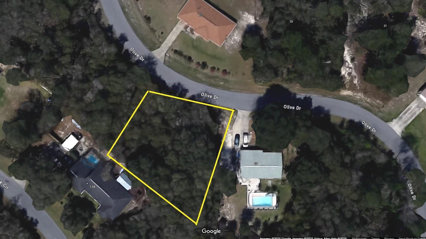 This is a satellite map view showing a vacant, wooded residential lot outlined in yellow — 26 Olive Drive, Ocala FL 34472, OCALA, FL
