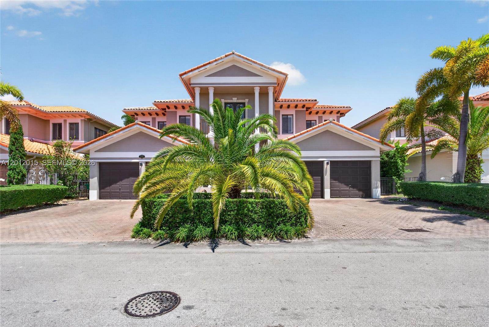 A two-story house with a central palm tree, two garages, and a tiled roof — 18841 SW 74th Ct, Cutler Bay FL 33157, CUTLER BAY, FL