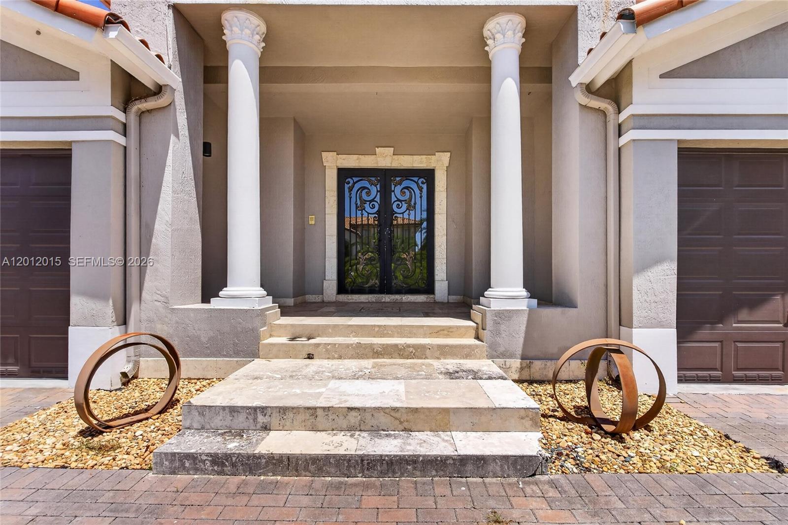 The exterior entrance features two white columns, stone steps, and decorative metal double doors — 18841 SW 74th Ct, Cutler Bay FL 33157, CUTLER BAY, FL