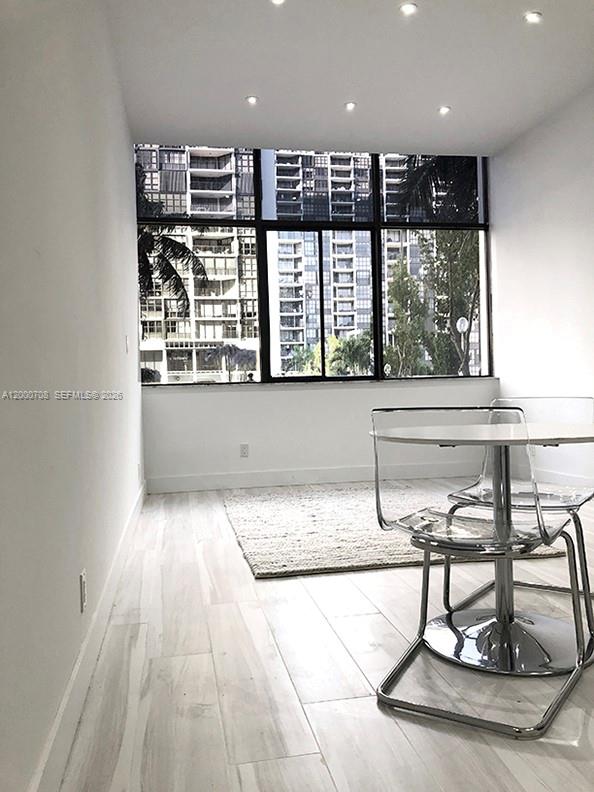 A small dining area features a white round table, two chairs, and a stainless refrigerator — 1915 Brickell Ave, Miami FL 33129, MIAMI, FL