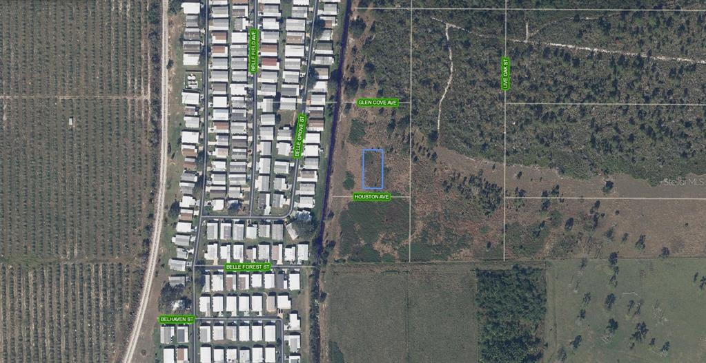 This aerial map shows a rectangular plot of land highlighted in blue near residential streets — 502 HOUSTON AVENUE, LAKE PLACID, FL