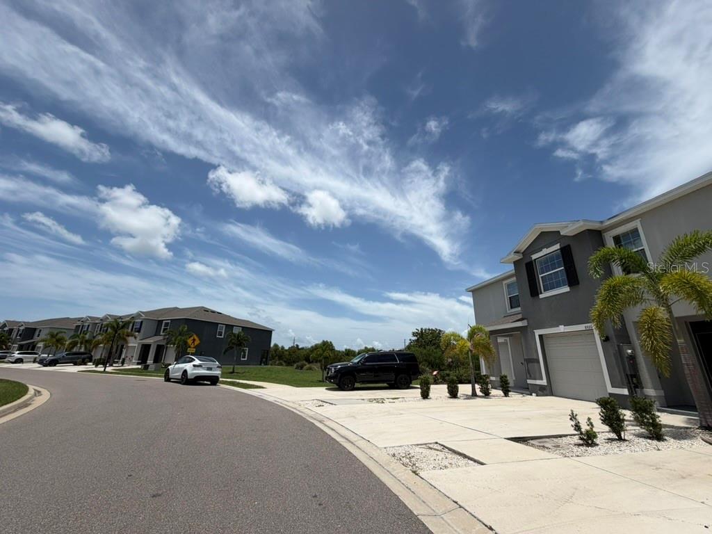 A two-story suburban house with a driveway and a black SUV parked in front — 8920 MILESTONE DRIVE, SARASOTA, FL