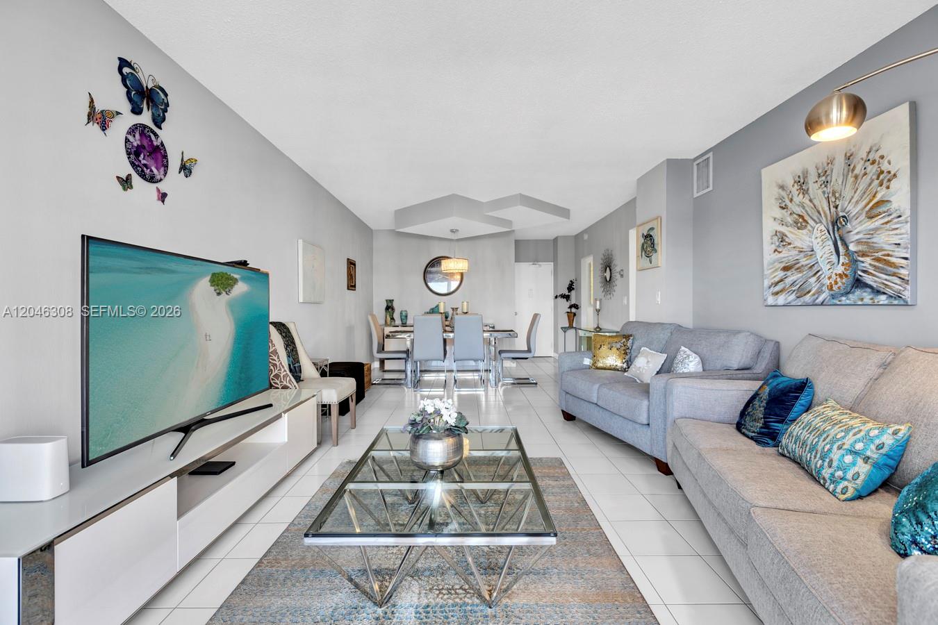A living room and dining area feature light gray walls, tile floors, and modern furniture — 1965 S Ocean Dr # 14C, Hallandale Beach FL 33009, HALLANDALE BEACH, FL