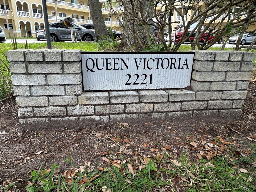 A brick sign displays the name Queen Victoria and the number 2221 outdoors — 2221 NORWEGIAN DRIVE UNIT 57, CLEARWATER, FL