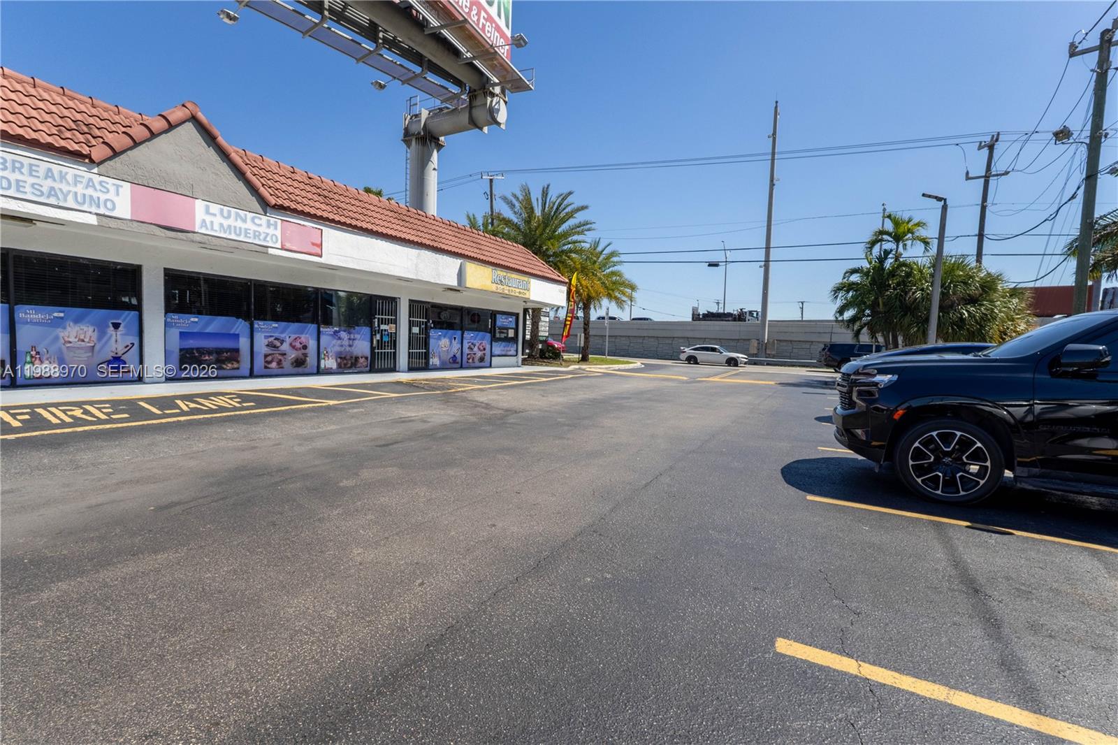 A commercial building with a red tile roof features a parking lot in front — 10550 NW 77 Ct, Hialeah Gardens FL 33016, HIALEAH GARDENS, FL