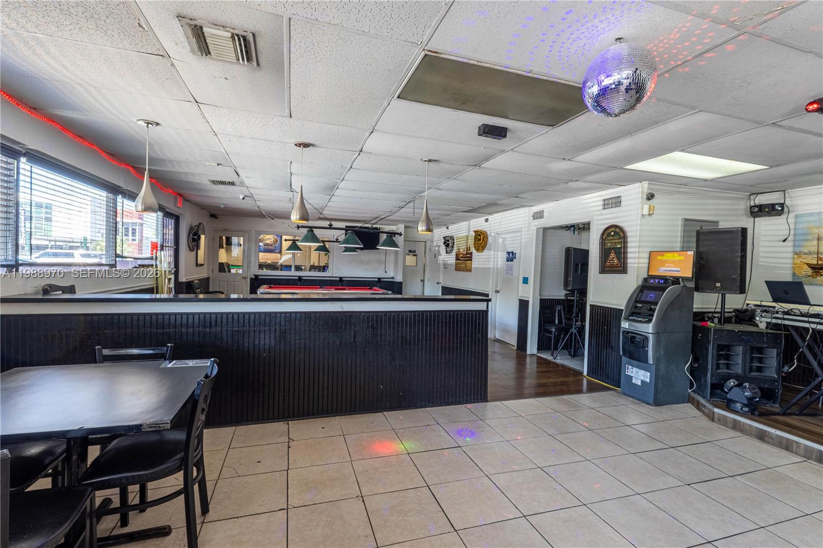 A bar interior features a pool table, an ATM, a disco ball, and tiled flooring — 10550 NW 77 Ct, Hialeah Gardens FL 33016, HIALEAH GARDENS, FL