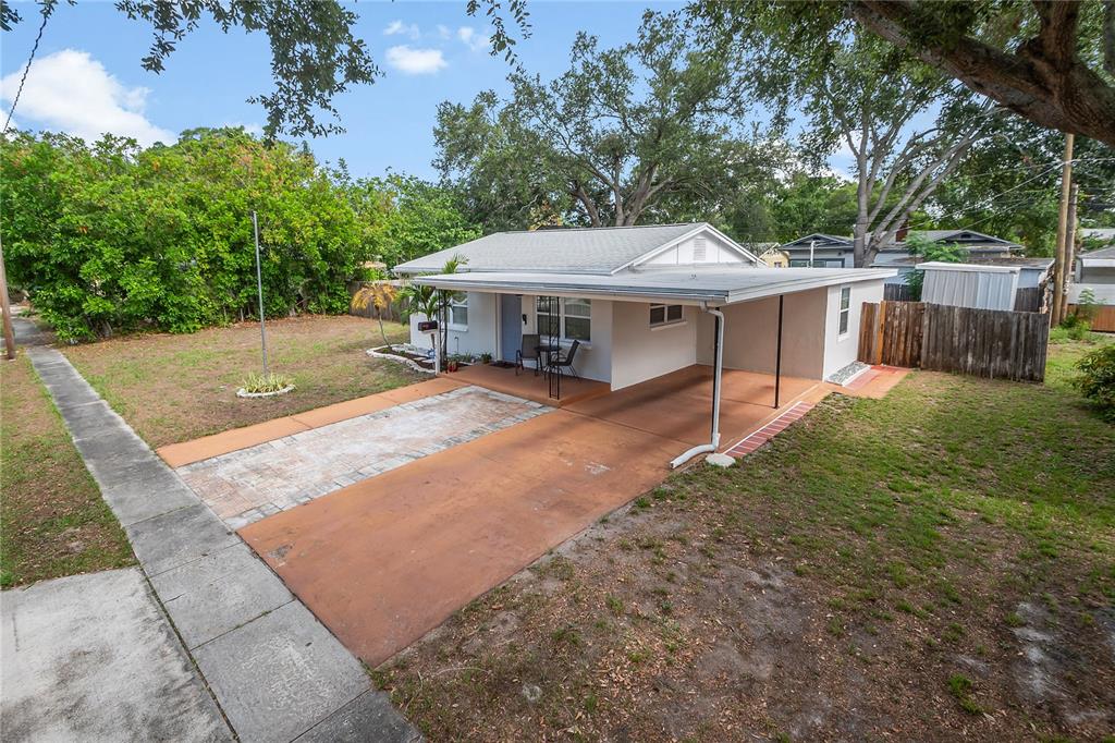 A single-story house with a carport, a paved driveway, and a front yard — 2151 44TH AVENUE N, ST PETERSBURG, FL