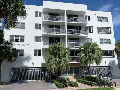 A multi-story white apartment building with balconies and a gated parking entrance — 1605 Bay Rd # 308, Miami Beach FL 33139, MIAMI BEACH, FL