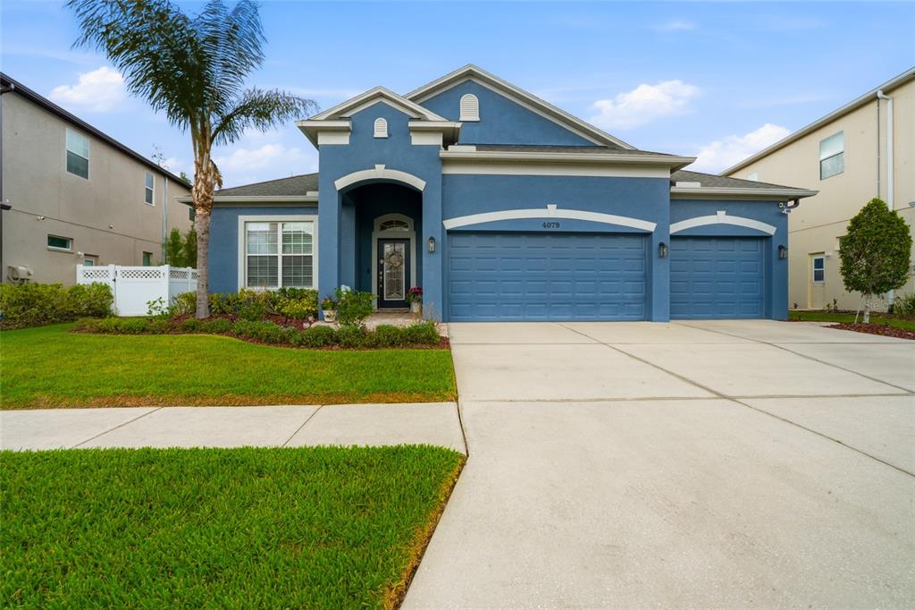 A room with light wood-look flooring, a window with blinds, a chair, and a world map — 4079 WINDCREST DRIVE, WESLEY CHAPEL, FL