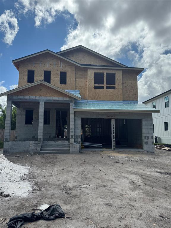 A two-story house under construction with white siding, a front porch, and an open garage — 2303 GLENWOOD DRIVE, TAMPA, FL