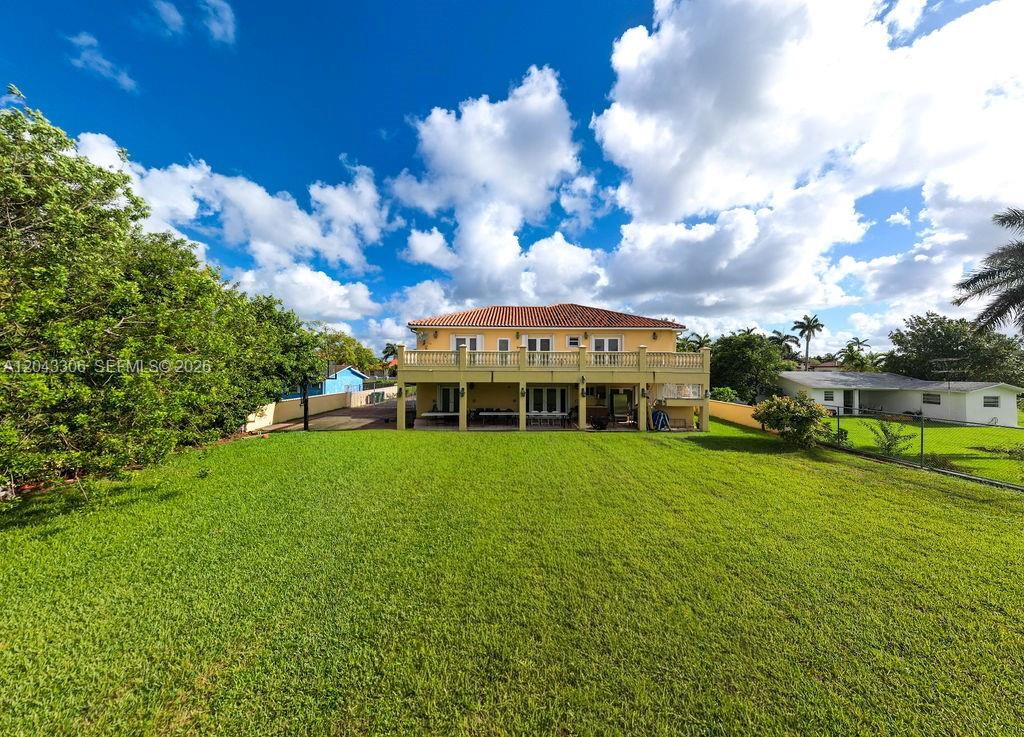A two-story house with a large backyard, balcony, and covered patio area — 13370 SW 34th St, Miami FL 33175, MIAMI, FL